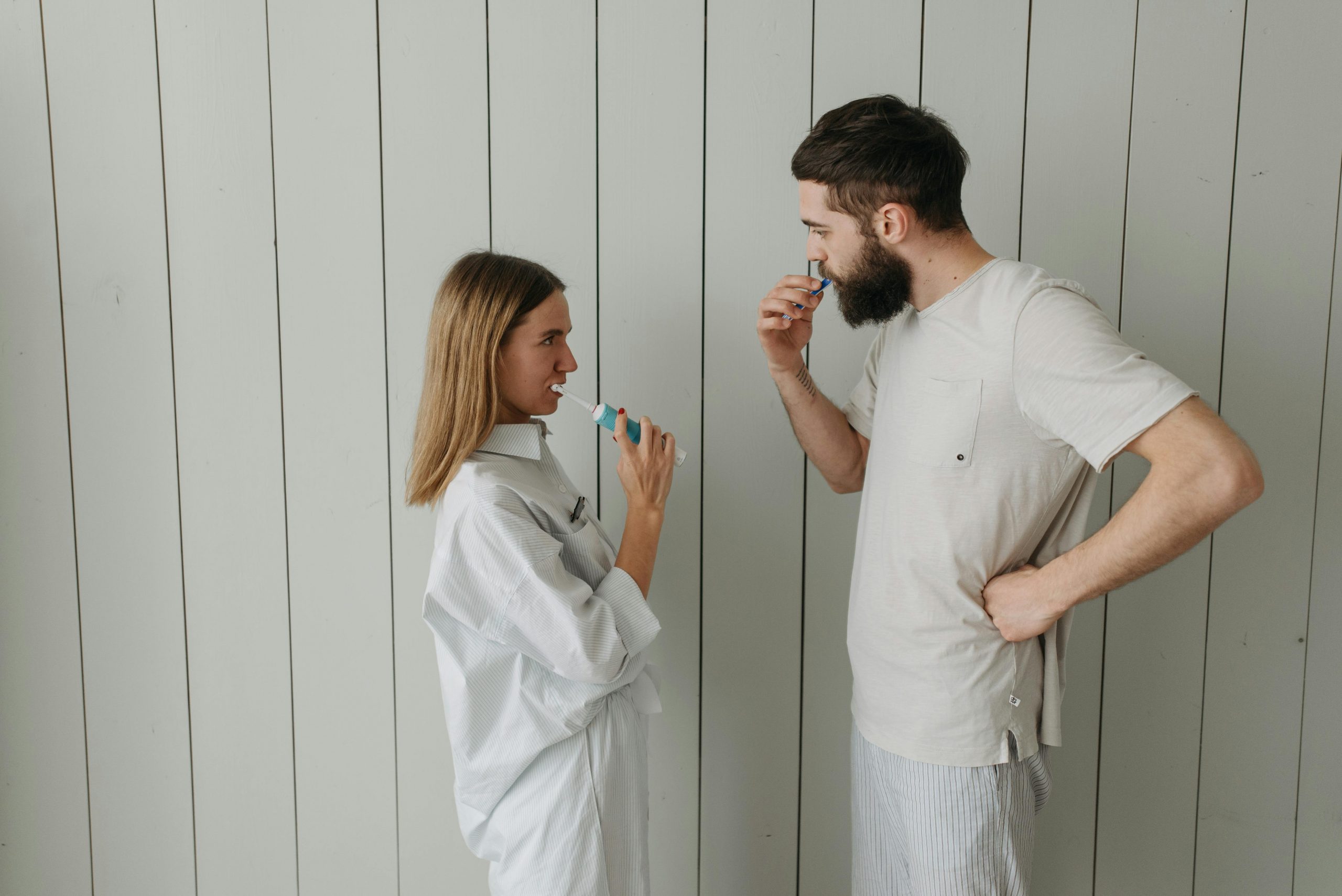 couple brushing their teeth together