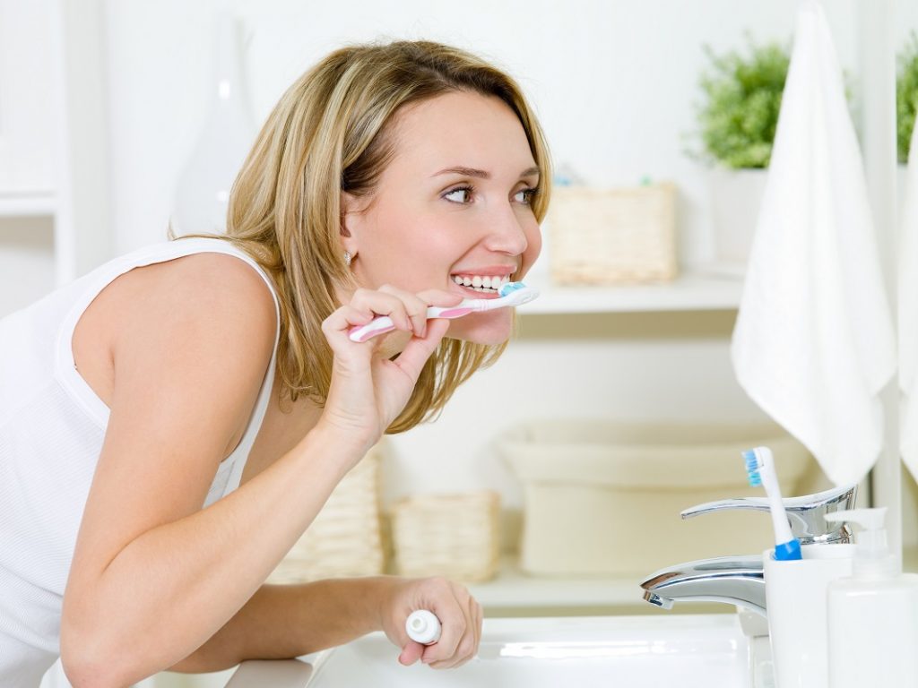 woman brushing her teeth